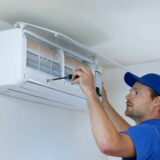 Technician installing an air conditioner