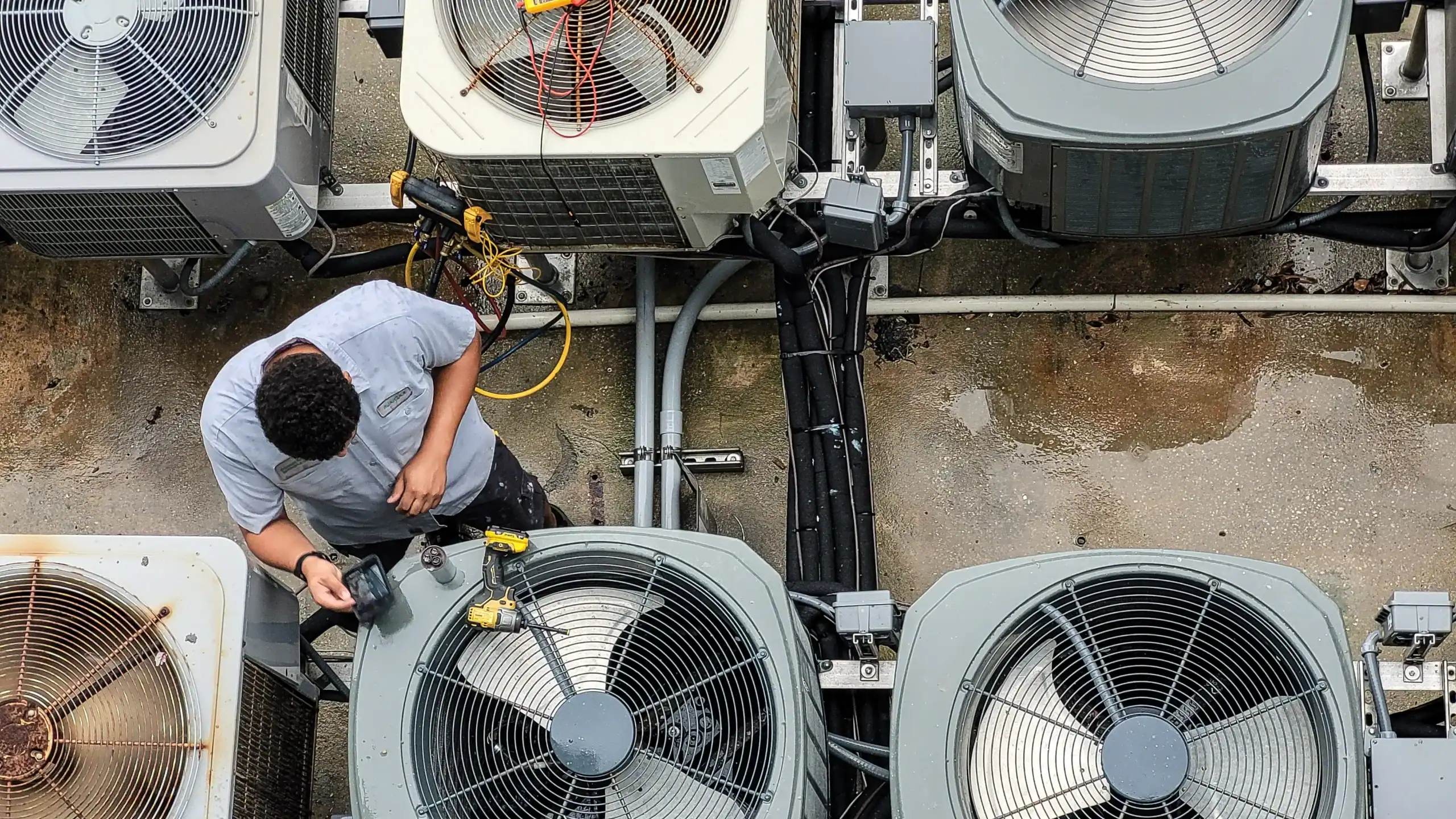 HVAC technician inspecting commercial air conditioning units for maintenance and efficiency.